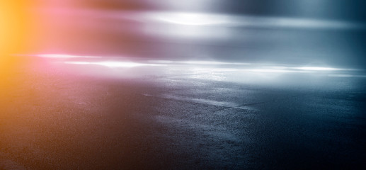 Wet asphalt, reflection of neon lights, a searchlight, smoke. Abstract light in a dark empty street with smoke, smog. Dark background scene of empty street, night view, night city.
