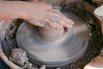 Hands of potter making clay pot