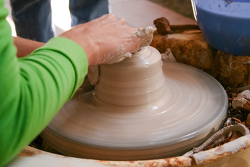 Hands of potter making clay pot