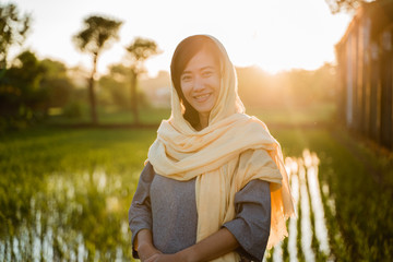 portrait of asian muslim woman with head scarf in the sunset outdoor