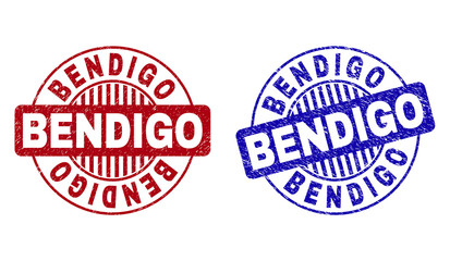 Grunge BENDIGO round stamp seals isolated on a white background. Round seals with grunge texture in red and blue colors. Vector rubber imprint of BENDIGO caption inside circle form with stripes.
