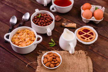 Tasty and useful breakfast with flakes, milk, nuts and dried fruits. The healthy food loading with energy