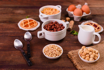 Tasty and useful breakfast with flakes, milk, nuts and dried fruits. The healthy food loading with energy