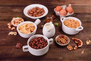 Tasty and useful breakfast with flakes, milk, nuts and dried fruits. The healthy food loading with energy