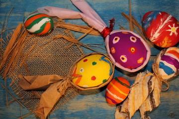  beautiful colorful, painted Easter eggs on blue wooden boards