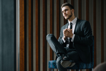 Young handsome businessman conducting negotiations with investors. Electronic business. Alternative...