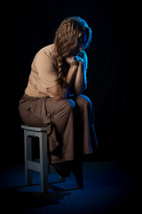 Girl Actress on stage plays emotions in blue theatrical light