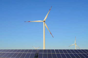 Wind power equipment and photovoltaic panels in the sky background