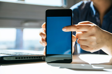 Close up of woman's hands using mobile phone touchscreen