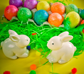 Fototapeta na wymiar LIttle porcelain Easter Rabbit sitting on the grass/ Symbol of Easter
