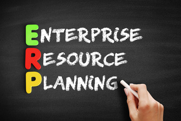 Fototapeta premium Color Wooden alphabets building the word ERP - Enterprise Resource Planning acronym on blackboard