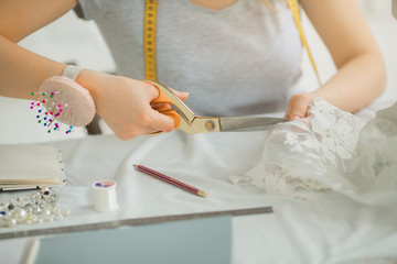 girl sews a dress in a sewing workshop
