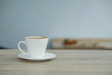 white cup of coffee on wooden table
