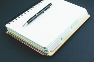 notebook and pen on the table