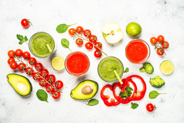 Red and Green vegetable smoothie on white.