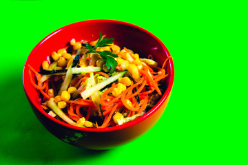 fresh carrot and corn salad in a red plate