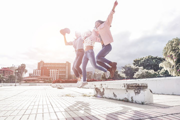 Millennial asian women jumping outdoor - Focus on right female body