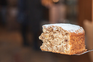 A stylish photo of a piece of a thin pie with fruit filling. Brown cake with berries.