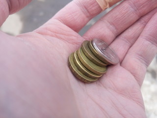 money coins in man's hand