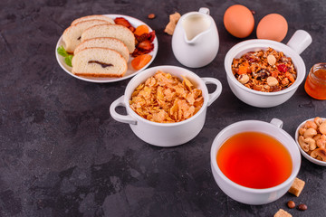 Tasty and useful breakfast with flakes, milk, nuts and dried fruits. The healthy food loading with energy
