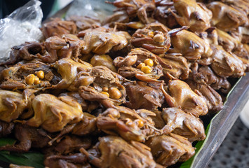 indonesian traditional food snack of grilled bacem quail chicken bird in the market
