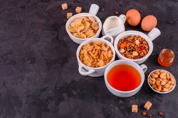 Tasty and useful breakfast with flakes, milk, nuts and dried fruits. The healthy food loading with energy