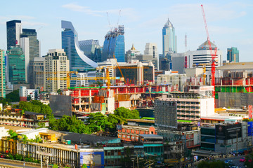 Naklejka premium City view in Bangkok where many of tall buildings are under construction among old and new buildings