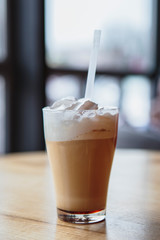 the process of preparing a delicious coffee drink with whipped cream that is decorated with coffee with milk