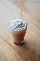 the process of preparing a delicious coffee drink with whipped cream that is decorated with coffee with milk