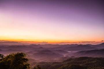 Fototapeta na wymiar purple sky sunset with scenery beautiful romantic mountain hill and fog in Chiang Mai 