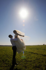 Happy married couple enjoying wedding day in nature