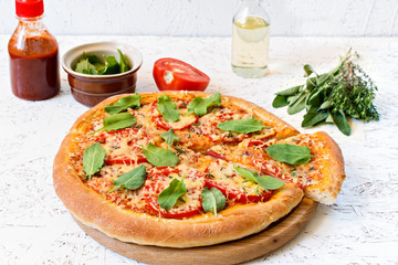 Pizza on a wooden board on a white background. Ingredients for pizza