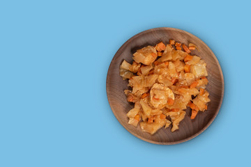 Steamed cabbage with meat and carrot isolated on blue background