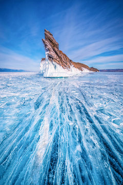 Tail of Ogoy island with natural breaking ice in frozen water at Lake Baikal, Siberia, Russia.