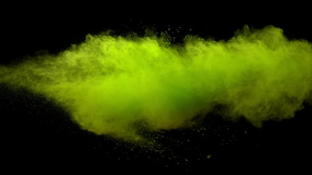 Super slowmotion shot of green powder explosion isolated on black background.