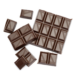 Dark organic chocolate pieces isolated on white background