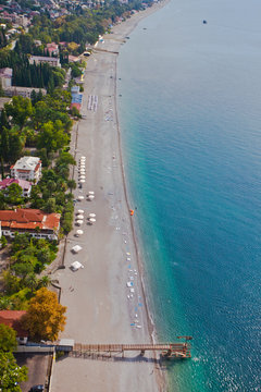 Top-down view is a beautiful seashore with a beach (aerial photo from paraglider), summer holidays in the Caucasus in Abkhazia.