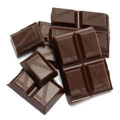 Dark organic chocolate pieces isolated on white background