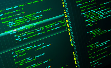 Web developing of the site using php language. Code on dark green background, macro