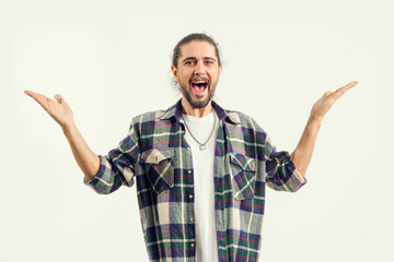 Sing. Happy man with a good mood. A young man screaming with joy and raised his hands up standing on a light background.