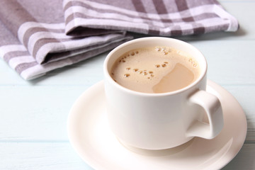 cup of coffee on wooden background top view.
