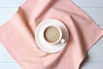 cup of coffee on wooden background top view.