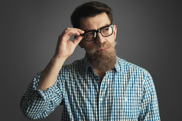 retro style portrait of a man with mustache and beard wearing glasses