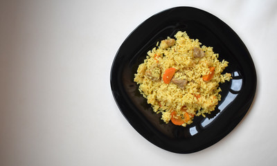 Black dish with food.