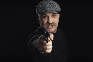 Portrait Of Angry Man With Gun On Black Background