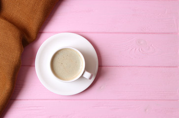 cup of coffee on wooden background top view.