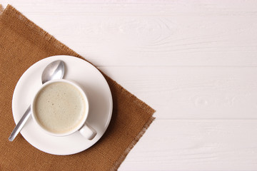cup of coffee on wooden background top view.