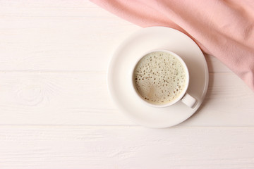 cup of coffee on wooden background top view.