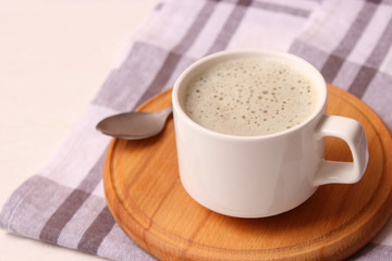 cup of coffee on wooden background top view.