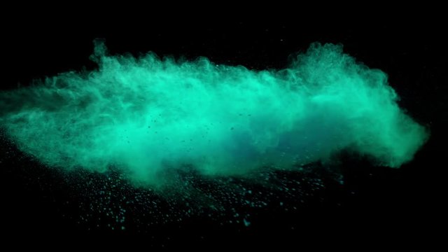 Super slowmotion shot of green powder explosion isolated on black background.